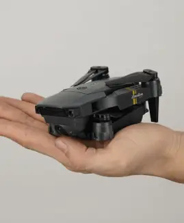 man's hand holding StealthWing4K Drone